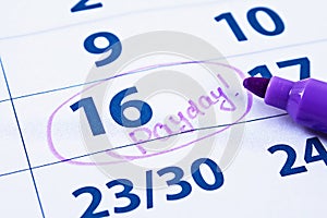 Payday concept. Business, finance, savings money. Calendar with marker circle in word payday