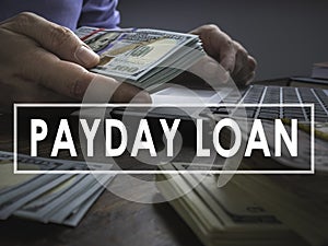 Payday loan concept. The man offers wad of cash.