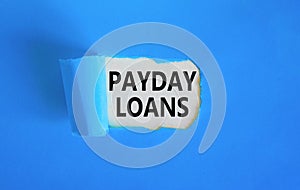 Payday loans symbol. Concept words Payday loans on beautiful white paper. Beautiful blue table blue background. Business and