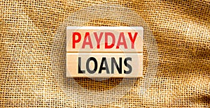 Payday loans symbol. Concept words Payday loans on beautiful wooden block. Beautiful canvas table canvas background. Business and