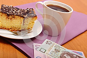 Paying for cheesecake and coffee in cafe using polisg currency money