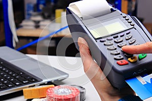 Paying with credit card in an electrical shop, finance concept