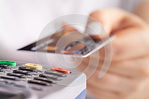 Paying with credit card. Female inserting chip card into payment terminal device