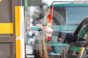 paying for fast food from the car at drive-through