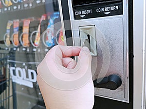 Paying with a quarter coin in a vending machine