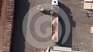 Payloader Loading Bulk Of Sawdust Into Trailer Truck At Wood Factory