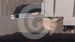 Payloader Loading Sawdust Into Trailer Truck At Sawmill Industry