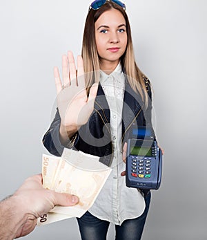 Payment card in a bank terminal. The concept of of electronic payment. woman in one hand holds payment terminal other is