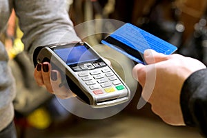 Payment by card, in the payment terminal. Electronic money. Mobile banking. Shopping complex.
