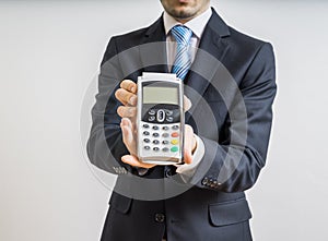 Payment with credit card. Businessman holds payment terminal in hand