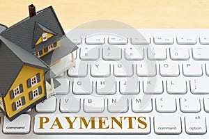 Payment message with a model house on gray keyboard