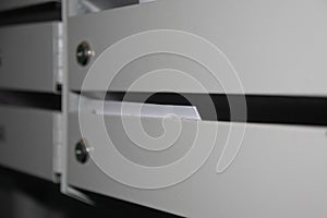 payment papers in gray iron mailboxes