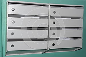 Payment papers in gray iron mailboxes