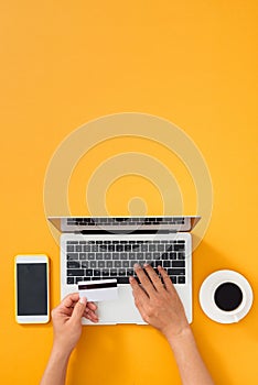 Payment process on the Internet. Closeup hand of men typing credit card details on laptop to complete payment process.