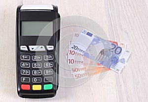 Payment terminal, credit card reader with currencies euro, cashless paying for shopping or products