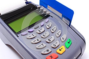 Payment terminal with credit card on white background