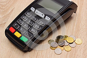 Payment terminal with polish currency, credit card machine on desk, finance concept