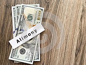 Payments alimony. Pile Dollars with sign alimony and money. Divorce and separation concept.