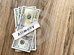 Payments alimony. Pile Dollars with sign alimony and money. Divorce and separation concept.