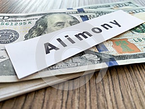 Payments alimony. Pile Dollars with sign alimony and money. Divorce and separation concept.