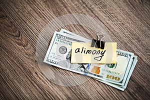 Payments alimony. Pile Dollars with sign alimony and money. Divorce and separation concept