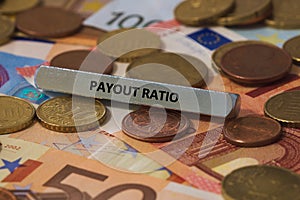 Payout ratio - the word was printed on a metal bar. the metal bar was placed on several banknotes