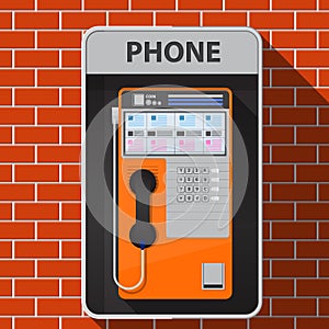 Payphone on brick wall.