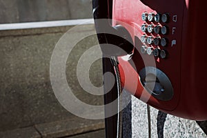 Payphone on the street of the city. Red phone.