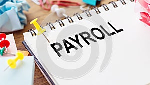 PAYROLL word on a small piece of paper