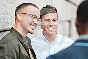 It pays to have business connections like these. three young businessmen having a discussion against an urban background