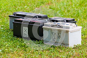 Pb lead car batteries on a grass in the nature photo