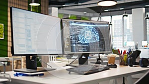 PC in empty IT startup office displaying artificial intelligence code