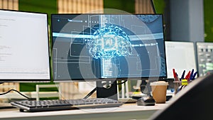 PC in empty IT startup office displaying artificial intelligence code