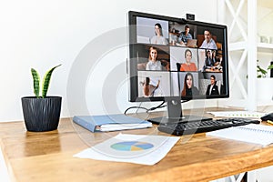 Pc screen with video conference on the table