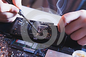 PC technology .Computer repair shop. Engineer performing laptop maintenance. Hardware developer fixing electronic