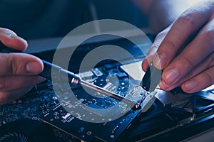 PC technology .Computer repair shop. Engineer performing laptop maintenance. Hardware developer fixing electronic