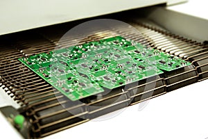 PCB drying technology. The finished board leaves the drying oven along the conveyor.