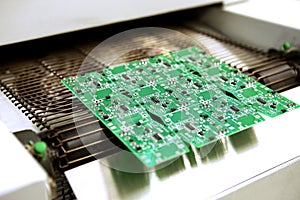 PCB drying technology. The finished board leaves the drying oven along the conveyor.