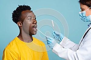 PCR Coronavirus Test. Doctor Taking Swab From Black Male Patient's Mouth