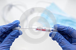 PCR test to COVID-19 in doctor hands, nurse holds tube of coronavirus swab collection kit
