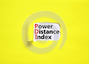 PDI power distance index symbol. Concept words PDI power distance index on white paper on a beautiful yellow background. Business
