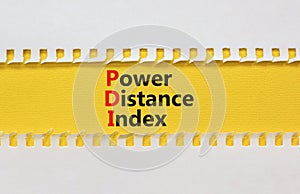 PDI power distance index symbol. Concept words PDI power distance index on yellow paper on a beautiful white background. Business