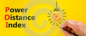 PDI power distance index symbol. Concept words PDI power distance index on yellow paper on a beautiful yellow background.