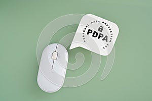 PDPA , Personal Data Protection Act text on real white speech bubble paper cut and wireless computer mouse on green background