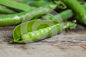 Pea pods on wooden table