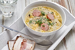 Pea soup with smoked sausage and rye bread with bacon.