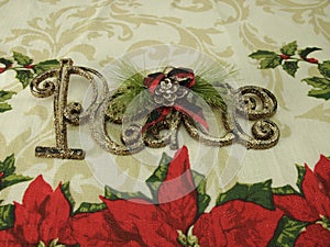 Peace for Christmas, poinsetta flowers, pine cones, ribbon