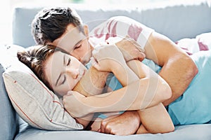 Peace, couple or hug while sleeping on sofa with love, safety and protection, rest or calm bonding at home. Sleep