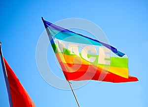 Peace flag with the word PACE in Italian against sky background