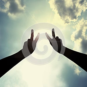 Peace hand gesture in sky